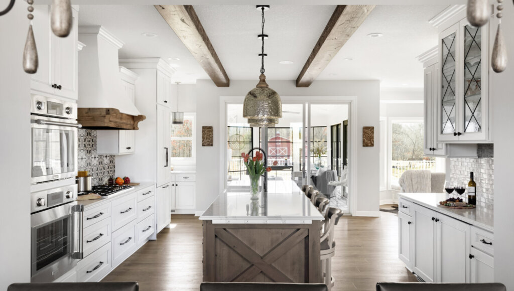 A dream kitchen idea with inspiring white countertops and cabinets, and brown accents on the island and ceiling.